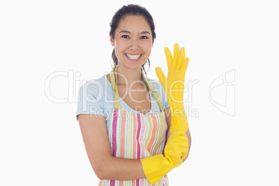 Smiling woman pulling on rubber glove