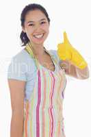 Woman in cleaning clothes giving thumbs up