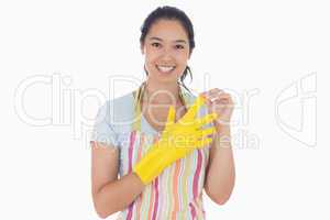 Smiling woman taking off rubber gloves