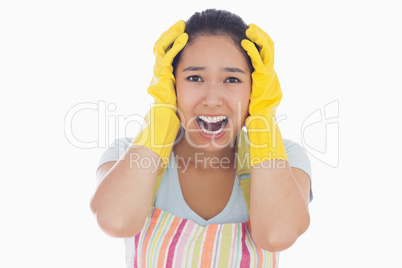 Distressed woman wearing apron and rubber gloves