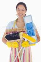 Woman holding mops and brushes