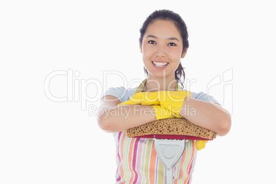 Happy woman leaning on mop