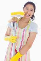 Distressed woman holding cleaning tools