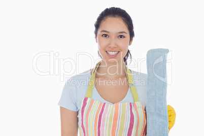 Smiling woman holding dust mop