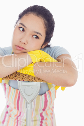 Fed up woman leaning on the mop