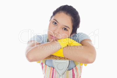 Sad woman leaning on mop