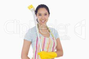 Happy woman with a broom on her shoulder