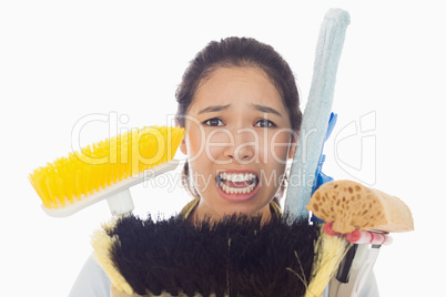 Very stressed woman with cleaning tools