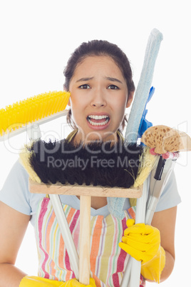 Distressed woman holding cleaning tools