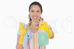 Cheerful woman holding up spray bottle