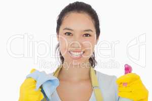 Smiling woman with cloth and spray bottle