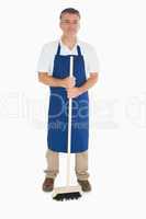 Man in apron with brush