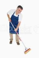 Happy man mopping floor