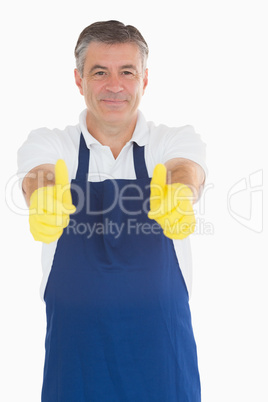 Man wearing apron giving thumbs up