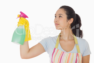 Young woman spraying cleaner