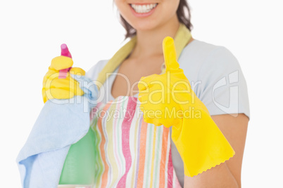 Woman giving thumbs up holding cleaning products
