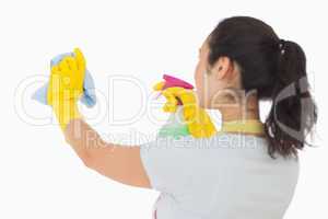 Woman spraying and wiping in rubber gloves