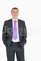 Smiling businessman with hands in pocket