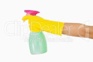 Woman in yellow rubber gloves holding window cleaner