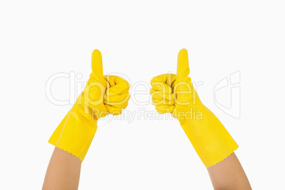 Female hands in gloves showing thumbs up