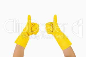Female hands in gloves showing thumbs up