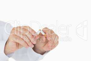 Male hands breaking a cigarette