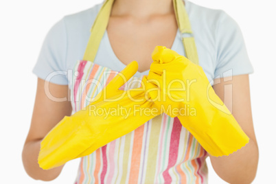 Woman taking off her rubber gloves