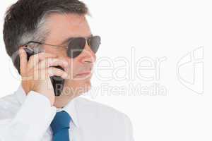 Man in suit and sunglasses on mobile phone