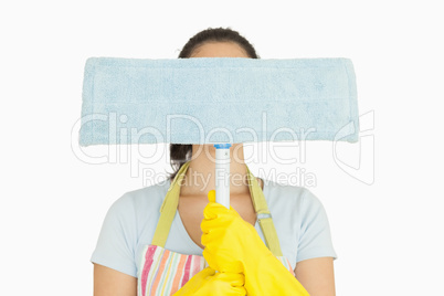 Woman hiding behind dust mop