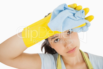 Cleaning woman wiping her brow