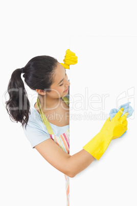 Laughing woman who washes plate form the side