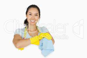 Smiling woman leaning on white surface