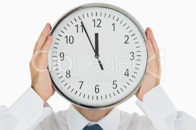 Man hiding face with a clock