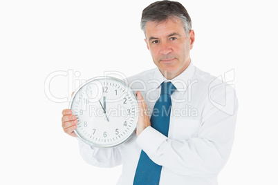 Businessman holding clock