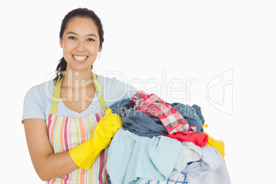 Laughing woman holding laundry basket