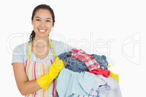 Laughing woman holding laundry basket
