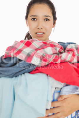 Woman overwhelmed with amount of dirty laundry