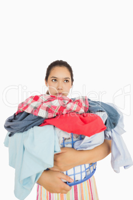 Exasperated woman holding laundry basket