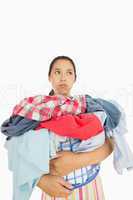 Overworked woman holding basket full of laundry