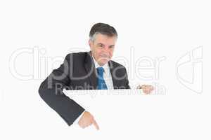 Smiling businessman pointing to board