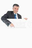 Happy businessman pointing at the board