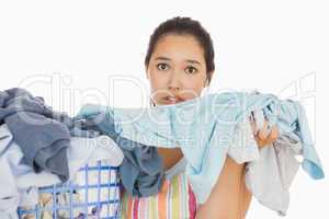 Frowning woman taking out dirty laundry