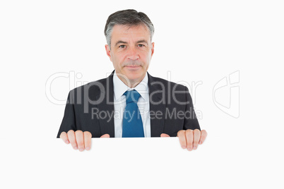 Thoughtful man standing behind white board