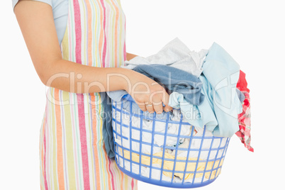 Woman holding a basket full of laundry