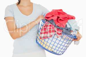Brunette holding a basket full of laundry