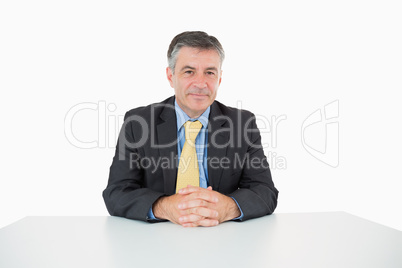 Well-dressed man sitting at his desk