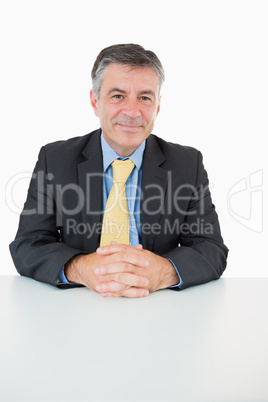 Happy man sitting at his desk