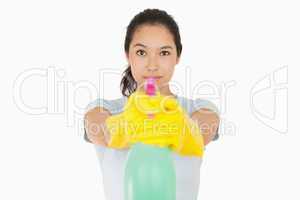 Woman pointing a spray bottle at the camera