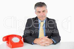 Man sitting at his desk with a phone