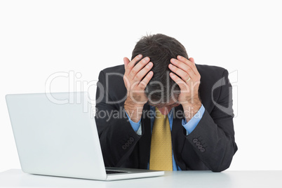 Frustrated businessman with laptop